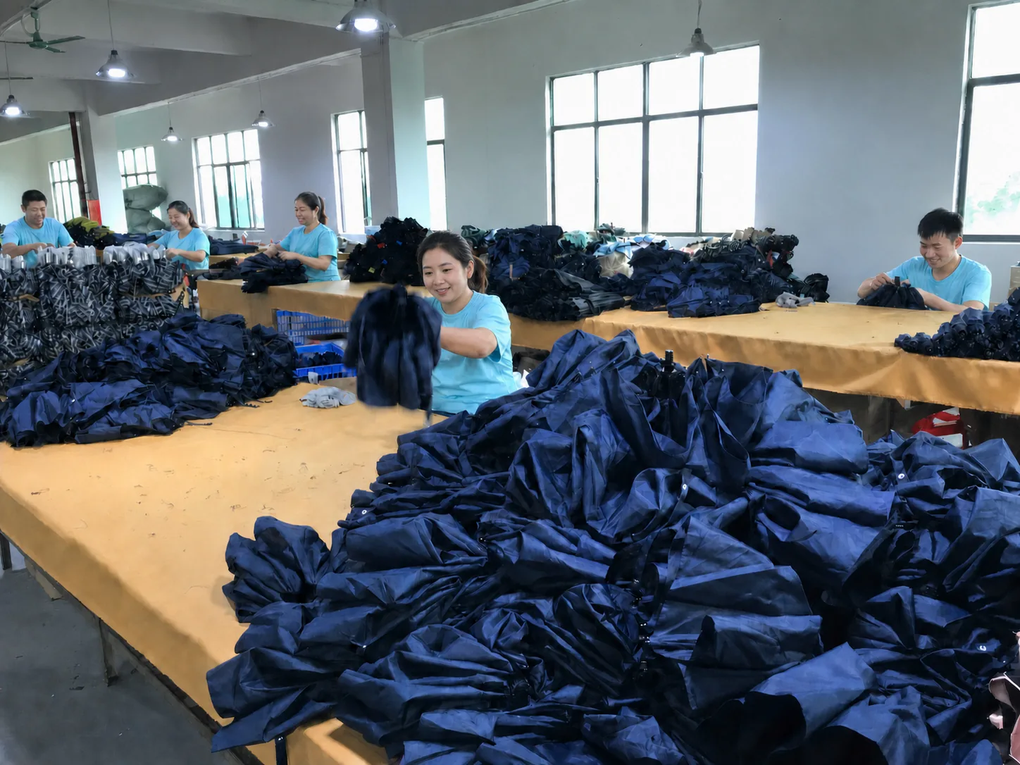Hand in Hand umbrella factory team assembling navy umbrellas in Heshan, Guangdong