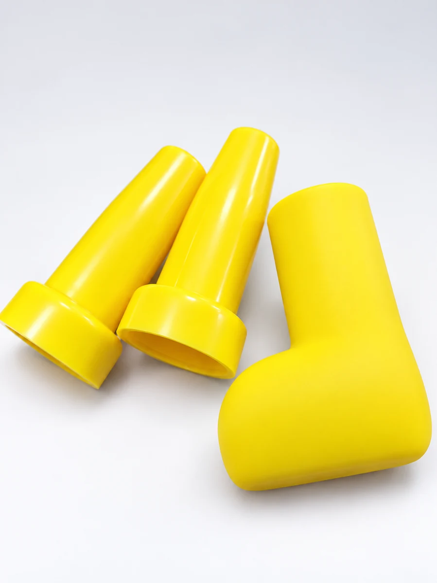 Yellow umbrella handle and top finial components on a light background