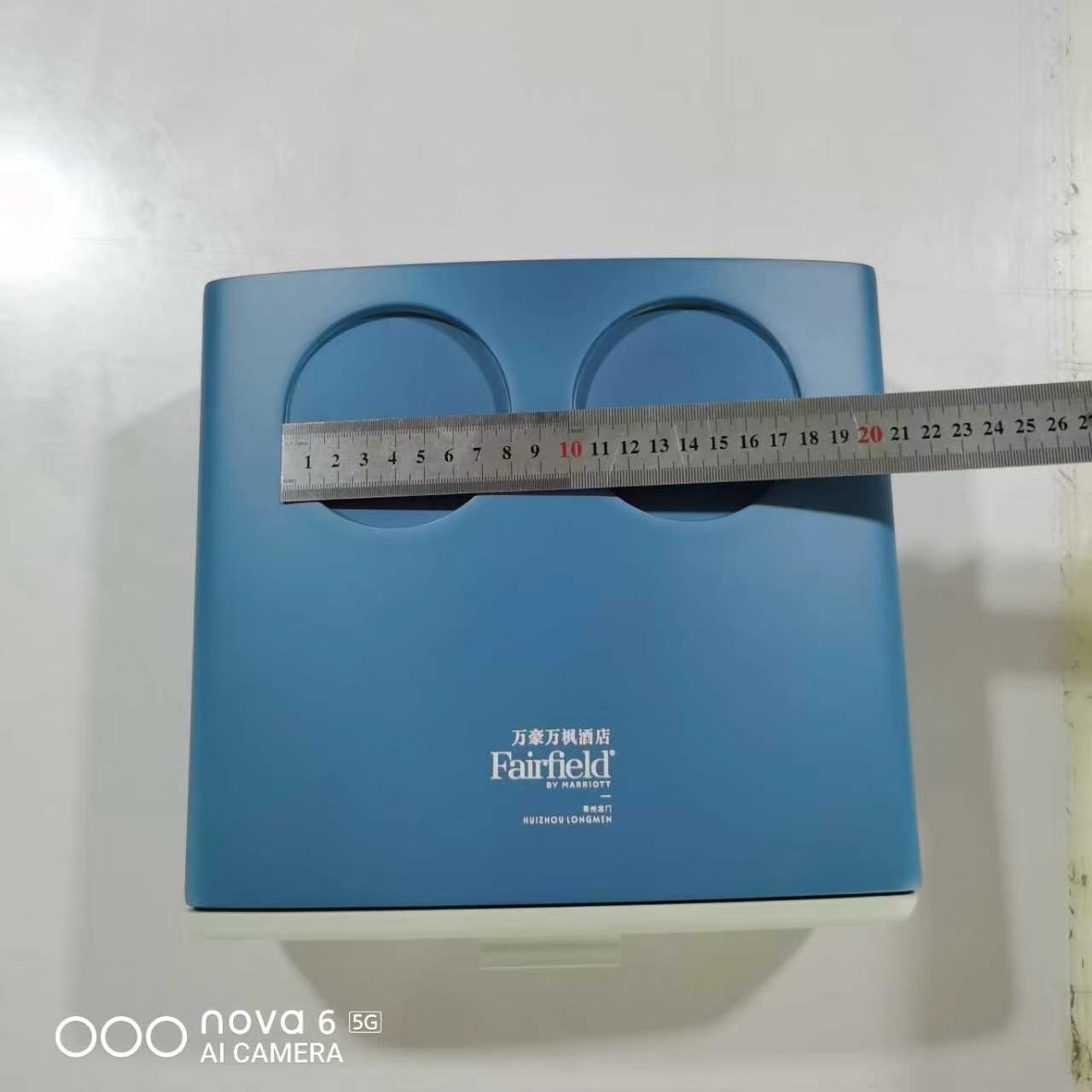 Customer-supplied physical brand-color reference used for hotel umbrella color development