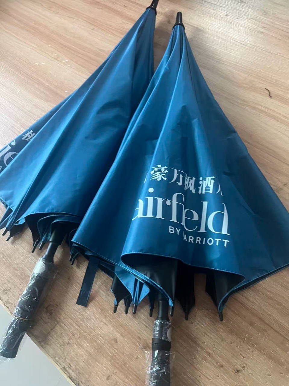 Second complete hotel umbrella sample showing the exterior canopy color and white logo