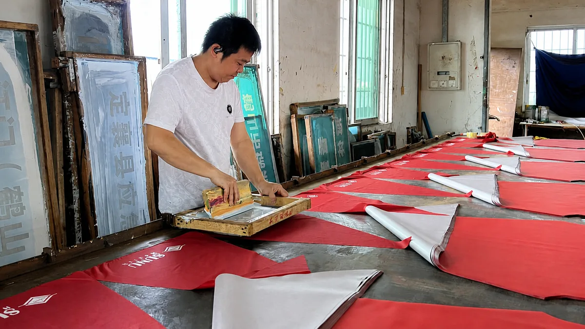 Screen printing one-color logos for a Nigerian order of 1,300 custom golf umbrellas
